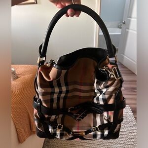 Burberry handbag with handle and strap.